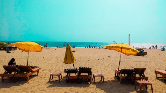 beach sand and yellow umbrellas @ Lamrin Ucassaim Hotel, Goa