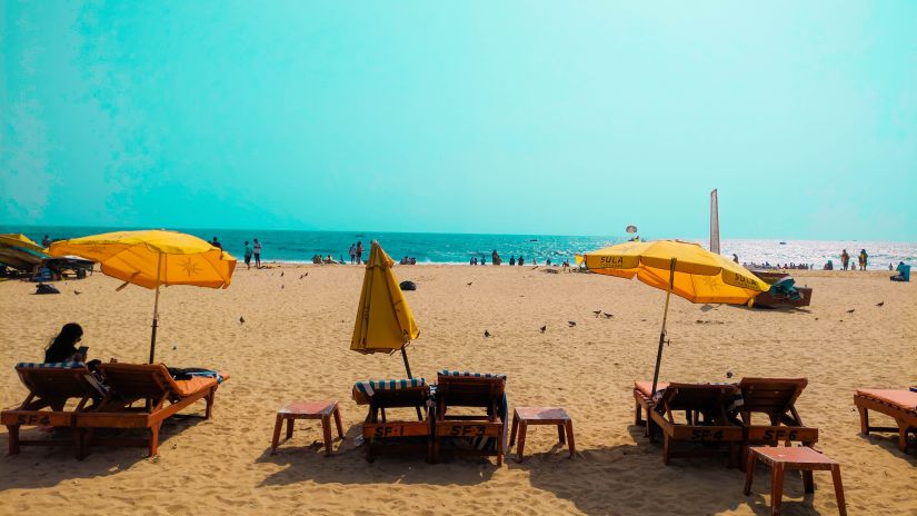 beach sand and yellow umbrellas @ Lamrin Ucassaim Hotel, Goa