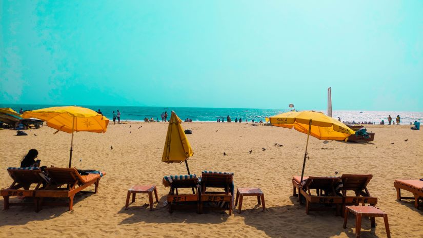 beach chairs under yellow umbrellas on Anjuna Beach