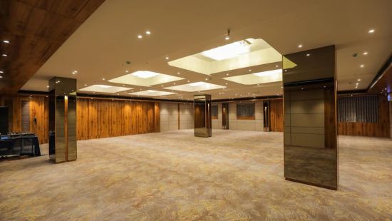 Platinum banquet hall at Comfort Resort, Morbi featuring lavish interior and well-lit ceiling