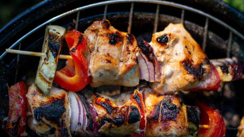 meat and vegetables being grilled