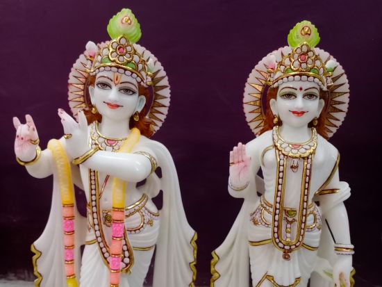 A close up shot of the hindu deities Krishna and Radha with a brown background