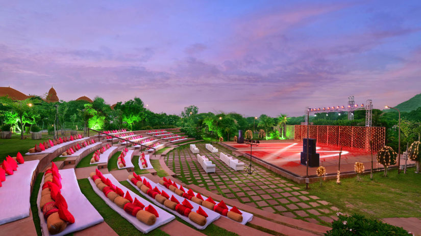 An overview of rangbhoomi amphitheatre with seating arrangements, lighting and speakers - The Ananta Udaipur