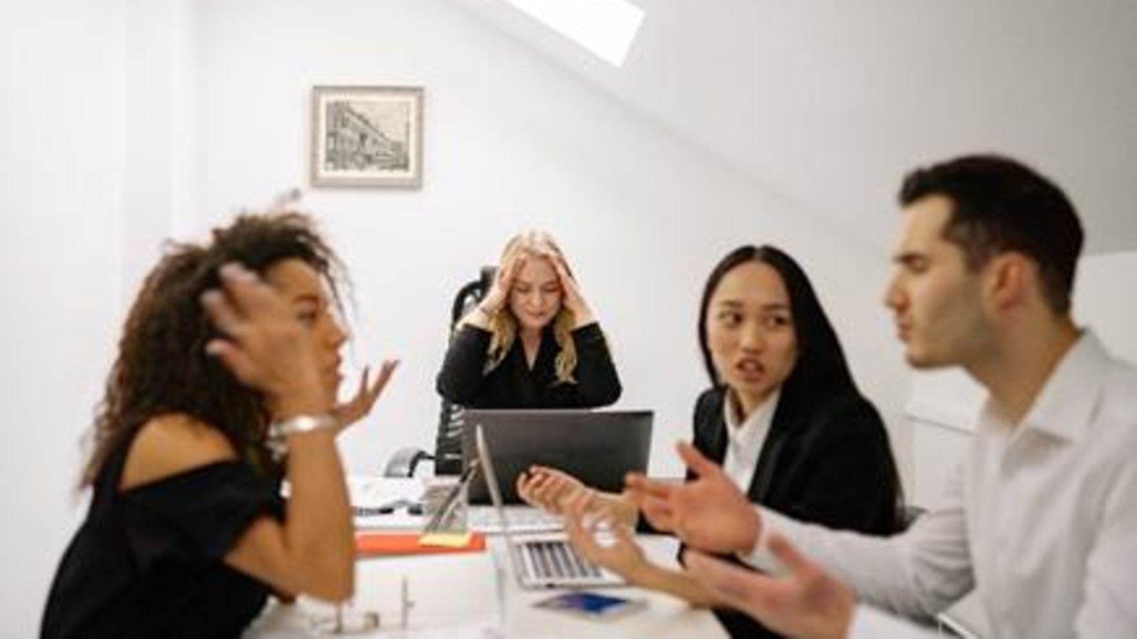 A group of people under stress in a conference room