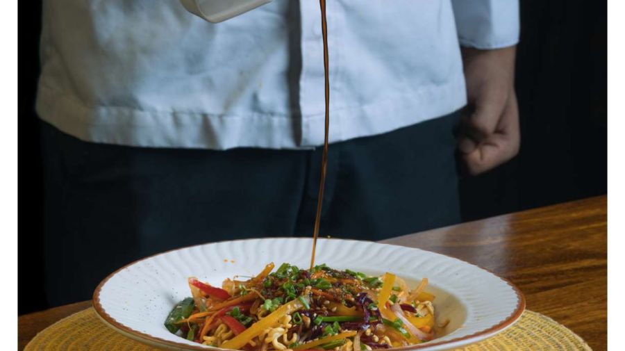 a close up shot of sauce being prepared on a dish