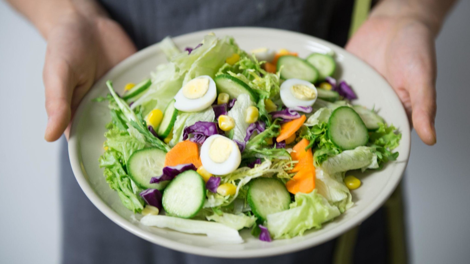 A person holding a food plate