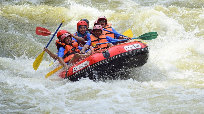 Group of people river rafting