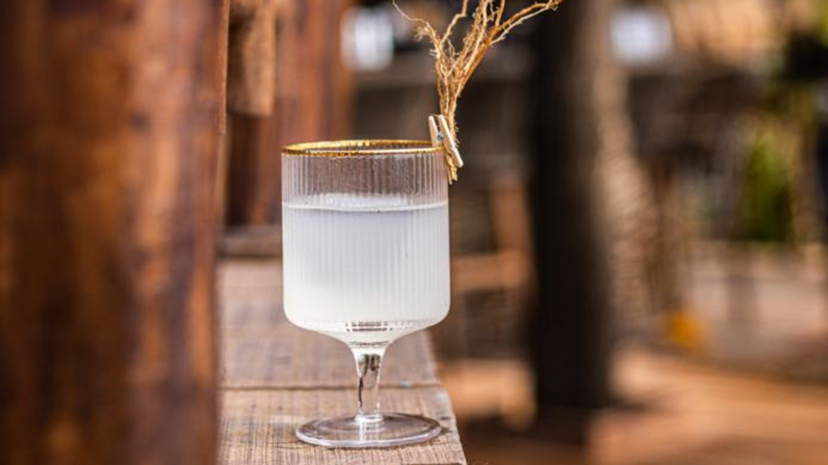 A wine glass filled with white liquid in it