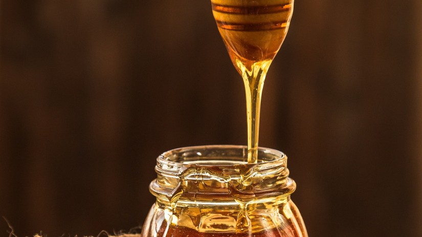 The Serai Kabini - a honey dipper over a jar of honey