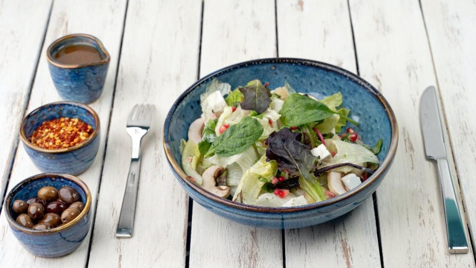 A salad bowl with sides on a table