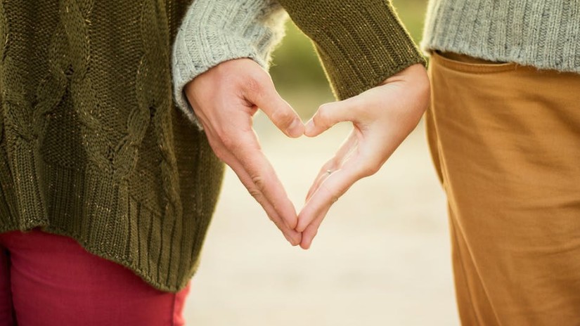 Couples making a heart shape and by hands