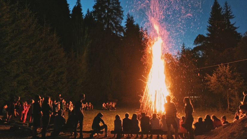 A bonfire was lit in the dark, surrounded by trees