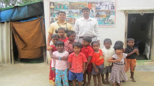 Students and 2 men posing for the camera