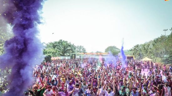 holi party with many people dancing