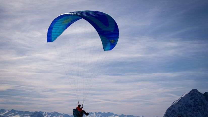 Paragliding on the mountain range overlooking the wide sky