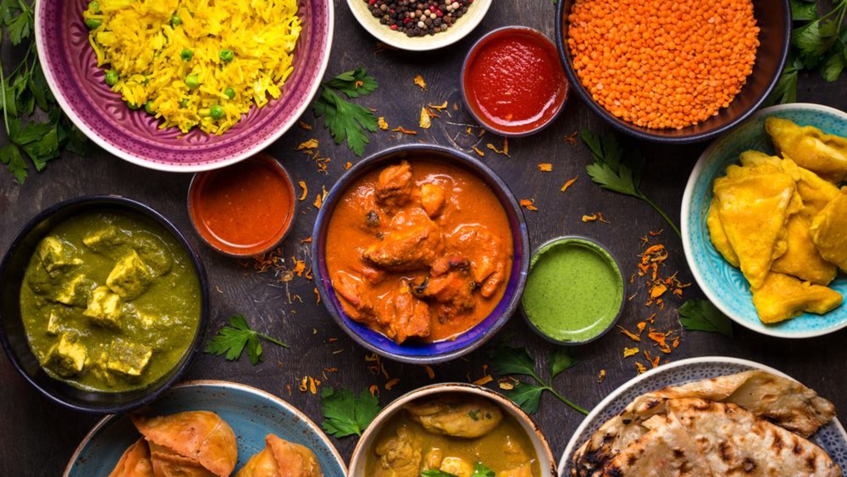 A table full of indian delicacies as seen from above