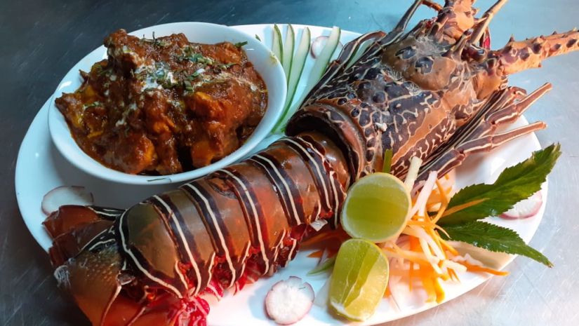 lobster on a plate with garnishes