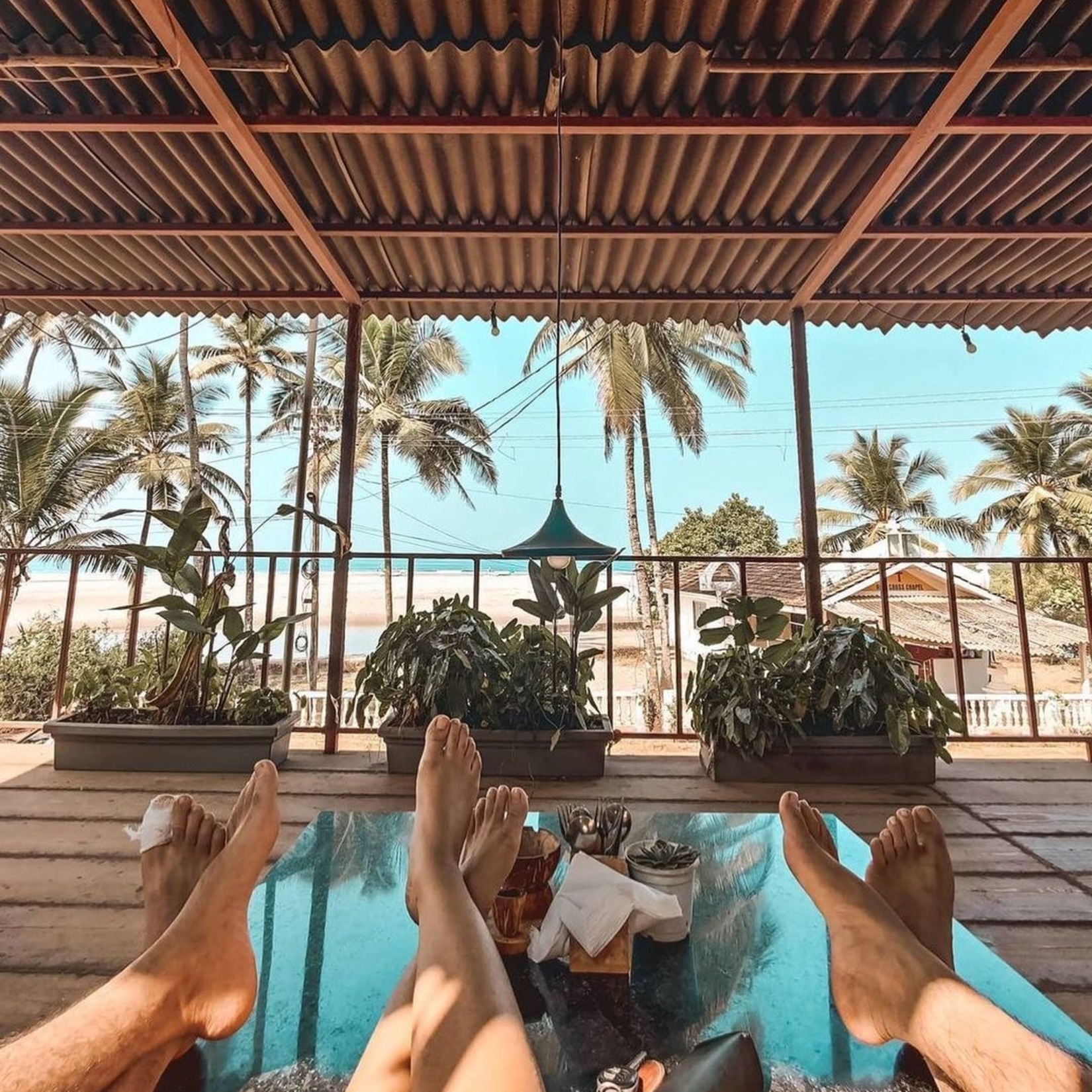 People lying on a deck in front of the beach