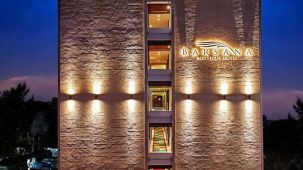 a tall hotel building constructed with bright lighting - Barsana Boutique Hotel Kolkata