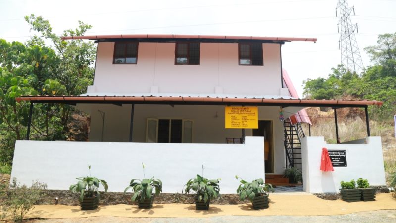 Pink two-storey building with white walls