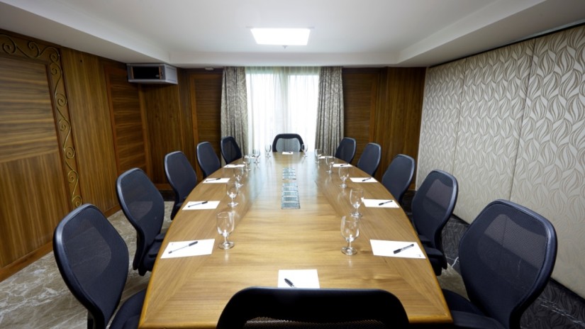 Table and chairs in a boardroom at Hablis Hotel, Chennai