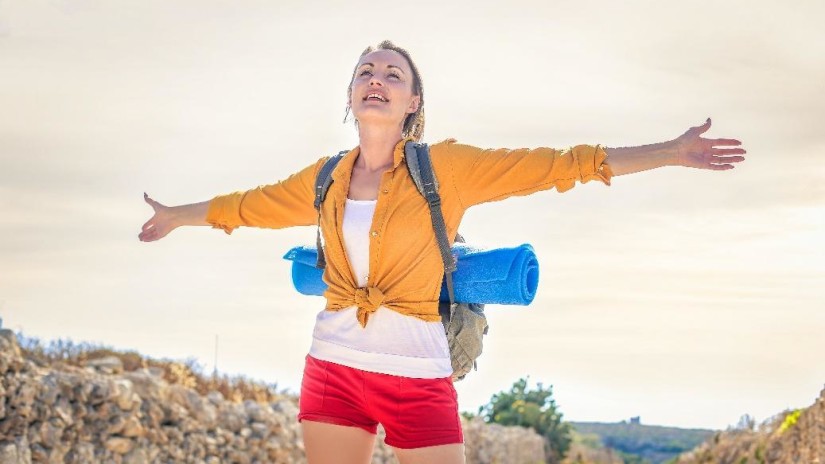 a woman standing with her arms open