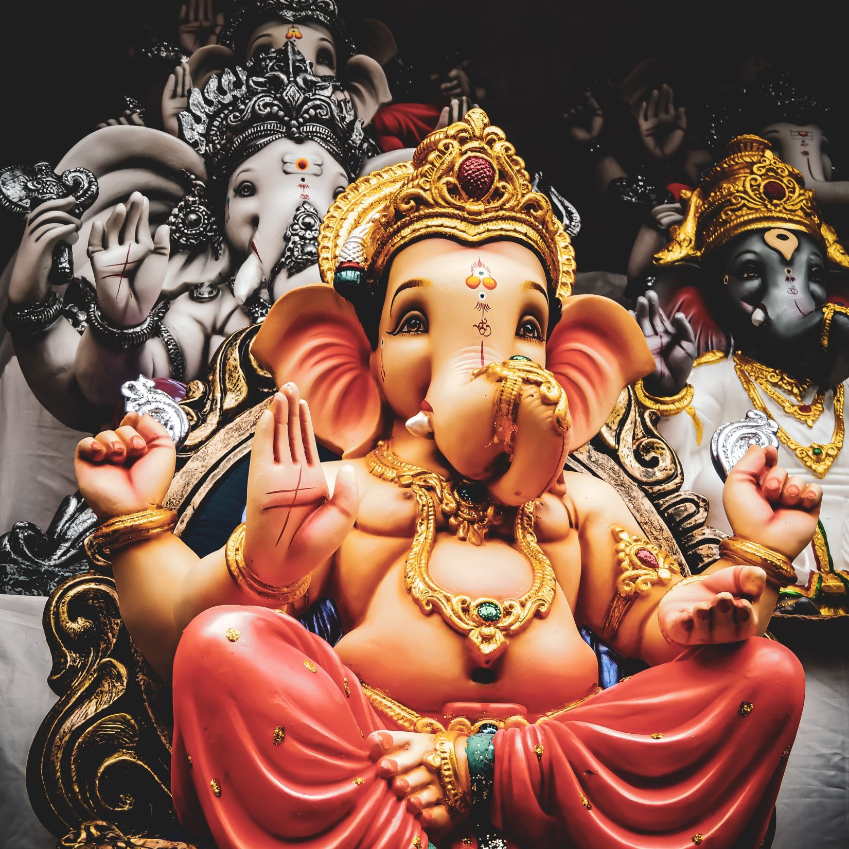 An idol of Lord Ganesh where he sits with his left leg folded and his right leg touching the floor