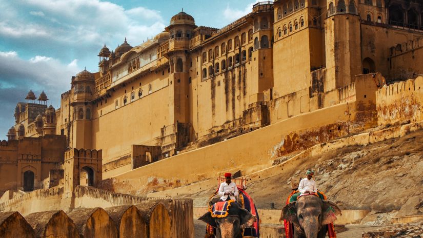 Royal palace in Rajasthan with people riding on elephant