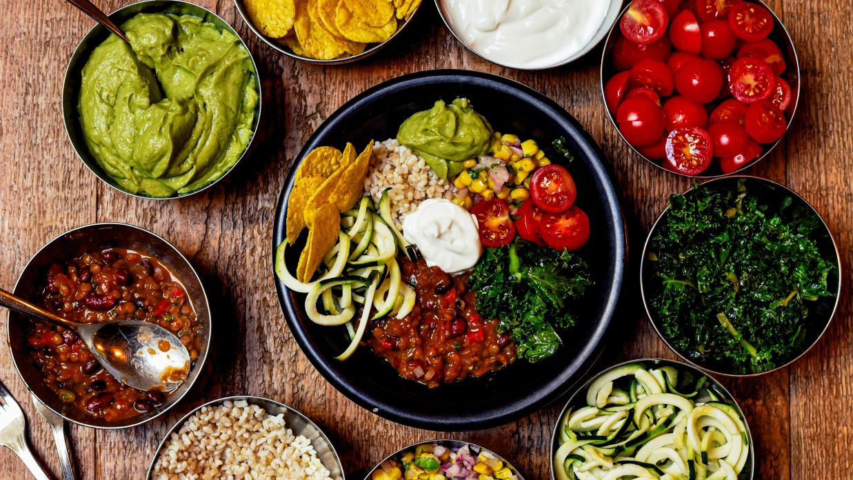 assorted vegetarian food bowls on a table