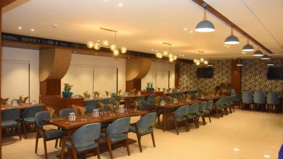 interior of food exotica displaying chairs and tables at Comfort Resort, Morbi