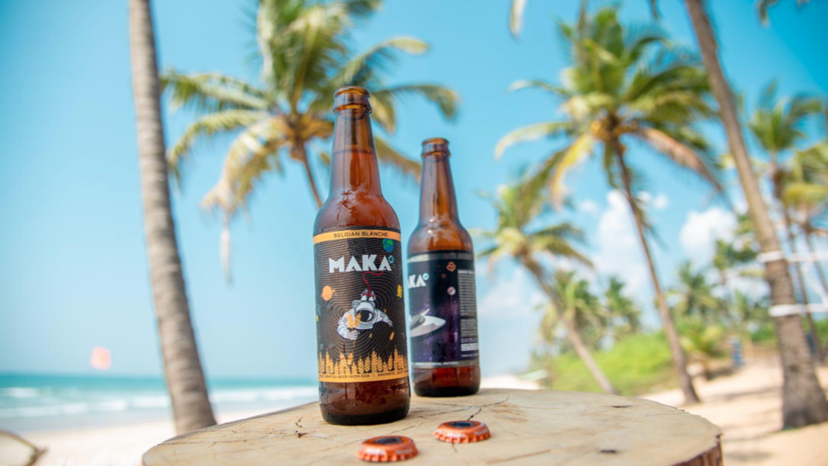 Beer kept on a table besides the beach