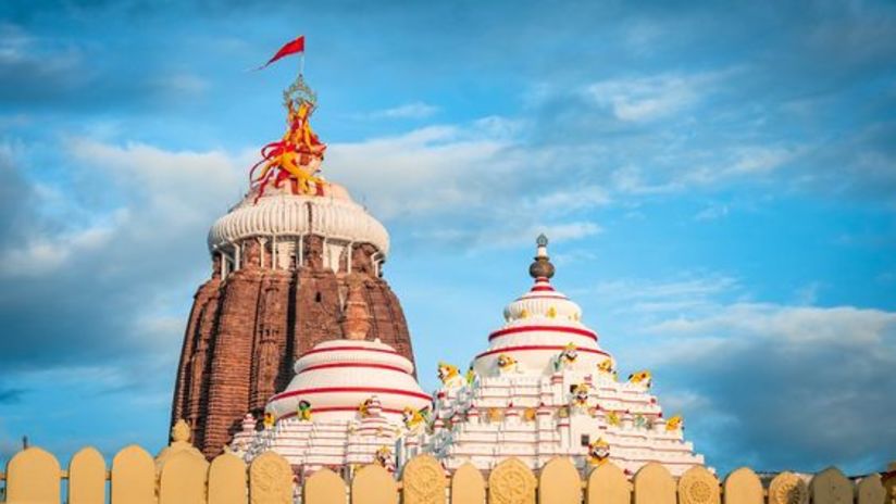 A colourful closeup image of a temple with a white dome