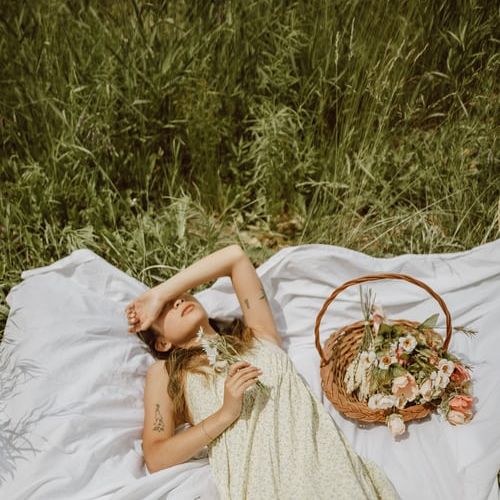 person lying down on a picnic mat