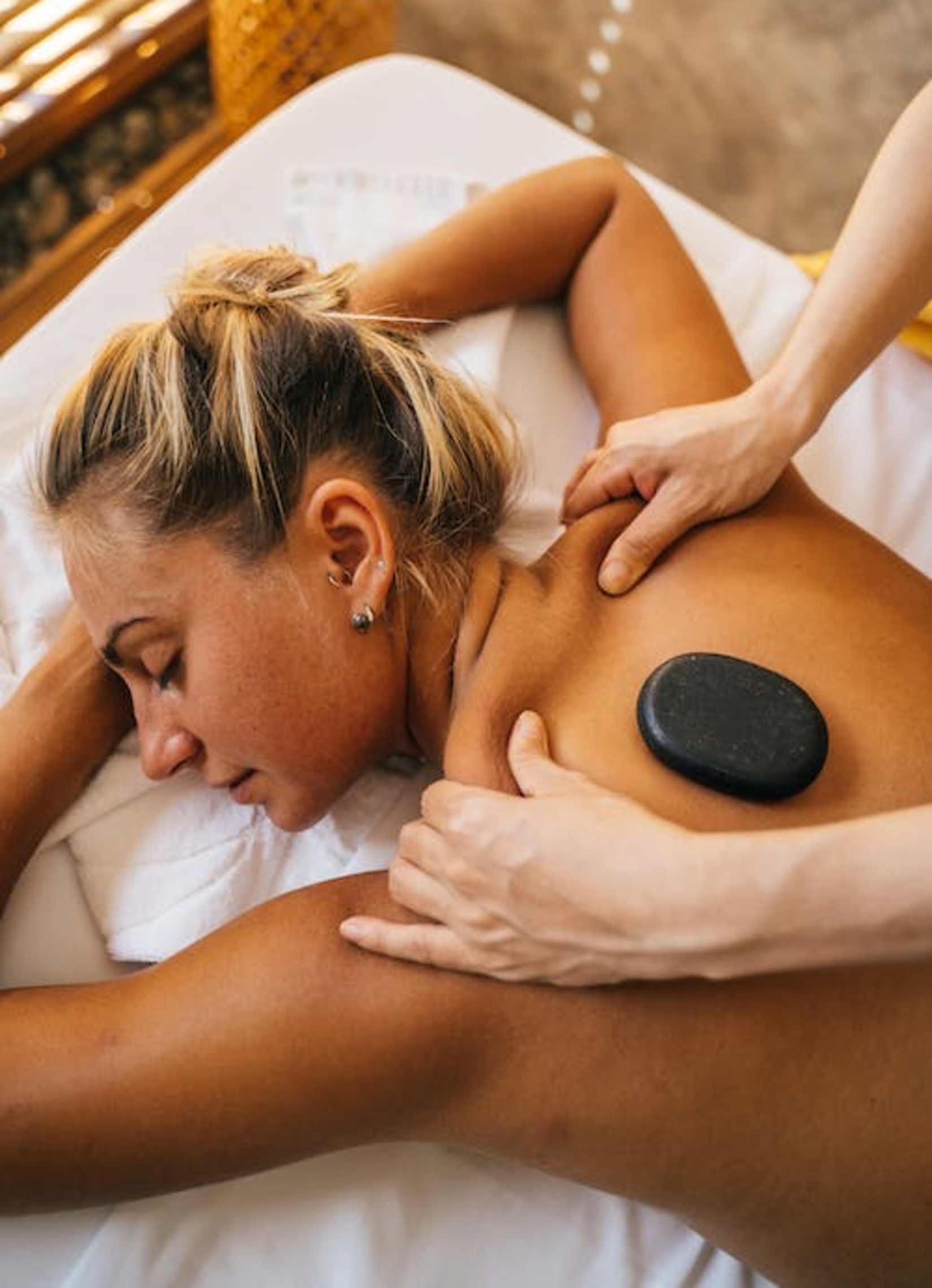 A woman receiving a back massage.