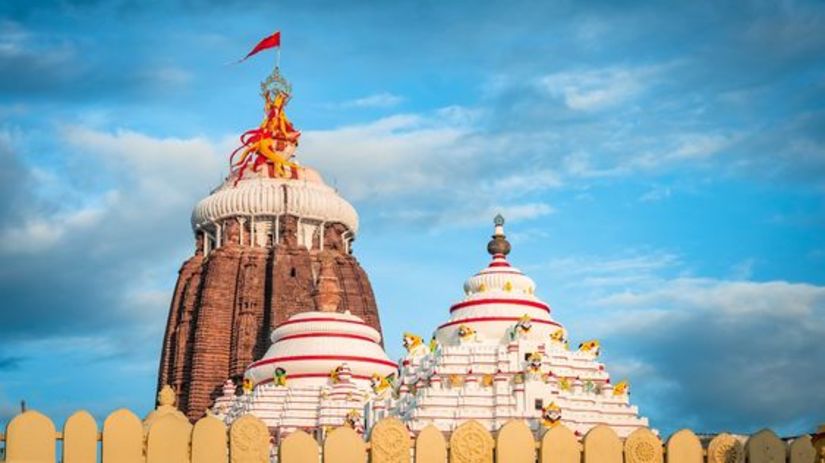 A colourful closeup image of a temple with a white dome