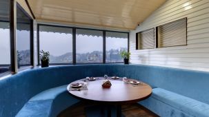 Lobby wit a round sofa and seating and a round table at the centre - Sumitel Boutique Resort, Darjeeling