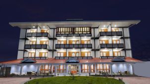 The well-lit facade of our hotel during nightime - Yashshree Lachung