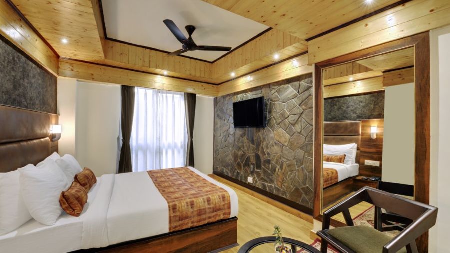 Premium  Room bedroom with a large bed and fan with large windows during daytime - Sumi Queensyard, Darjeeling