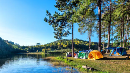 A group of tents near a lake