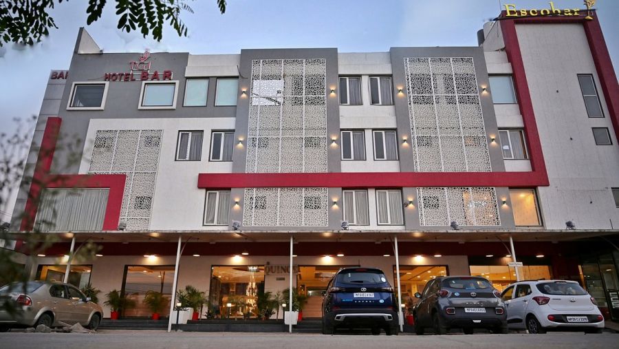 Exterior view of TGI Insignia hotel with parked cars in front - TGI Insignia, Bhopal