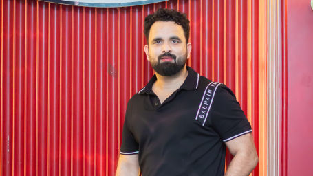 Image of guy posing in front of a the barbeque house at Themis Mudhouse- A Nature's Wellness Resort