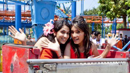 two women sitting on a adventurous ride at MGM Dizzee World