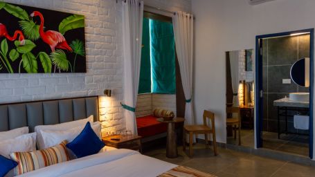 A mirror and a double bed inside Executive Room - The Sierra, Udaipur