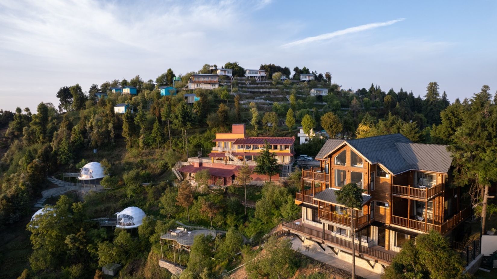 Aerial view of Facade of Avalon Retreat, Kanatal  on the hilltop surrounded by trees 