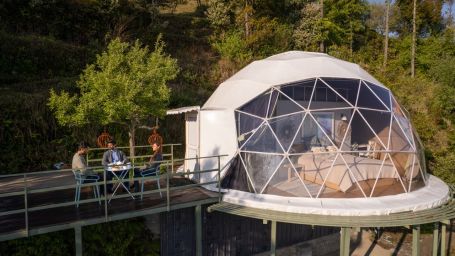 Exterior view of the dome accommodations with a balcony on the side at   Avalon Retreat, Kanatal