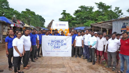 Tourism Day CSR Activity  with Lotus Eco Resort Konark staff where bunch are people are standing in U shape holding poster.