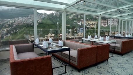 The seating arrangement in The House of Glass, a rooftop restaurant in Shimla - The Orchid Hotel Shimla