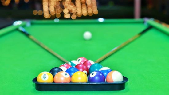 Billiards balls stacked on table at inflated trampoline surrounded by trees at Themis Mudhouse - A Nature's Retreat Resort & Wellness