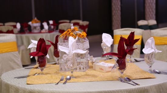 A banquet hall featuring a bunch of decorated chairs and tables 