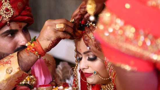 An Indian bride and groom are getting married.